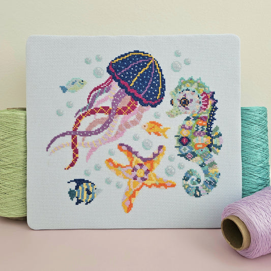 Completed Serene Seas cross stitch collection with matching needle minder from the Meloca Stitch Circle subscription