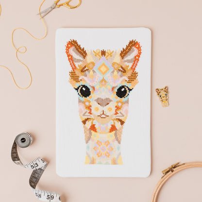 Mandala Alpaca cross stitch kit flat lay with DMC threads and stitching accessories